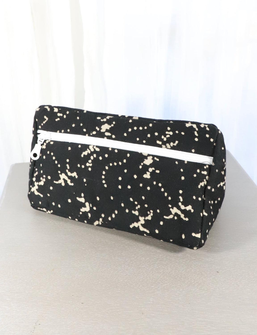 Black cotton block print toiletry bag, front view.