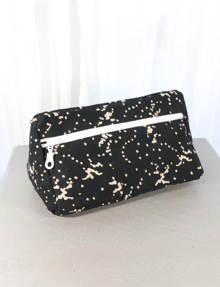 Black cotton block print toiletry bag with a floral and dot pattern.