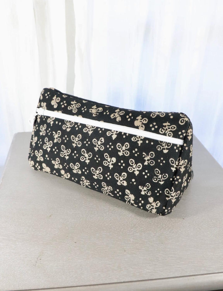 Black cotton block print toiletry bag with a floral pattern.