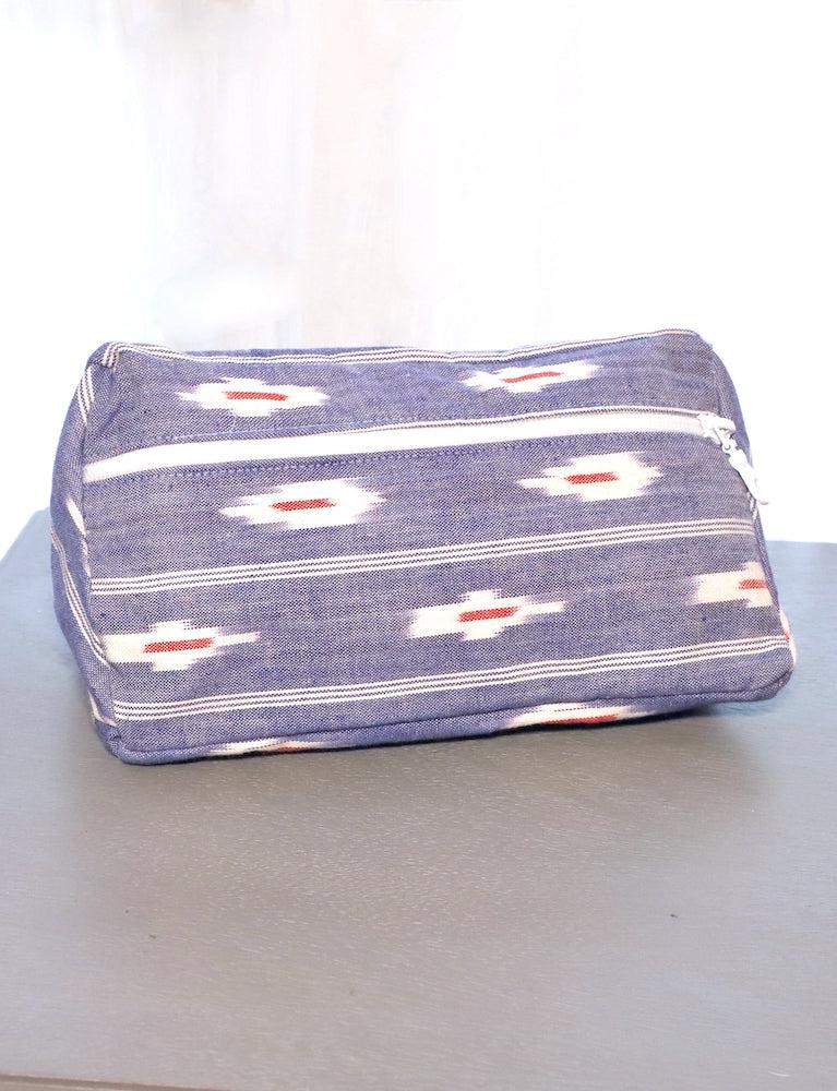 Blue ikat cotton toiletry bag with a zipper closure.
