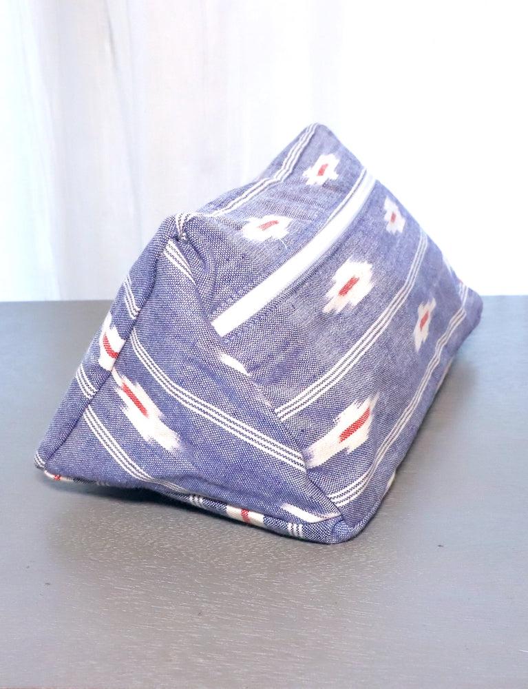 Blue ikat cotton toiletry bag with a zippered closure, compact travel size.