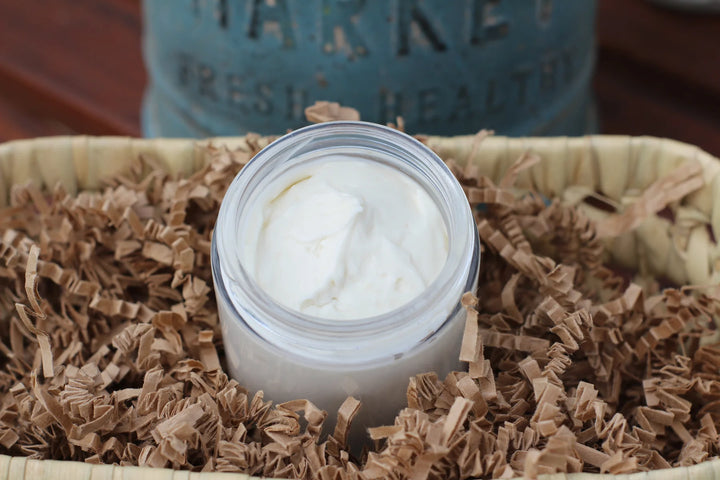 Natural magnesium body butter in a jar with a textured lid.
