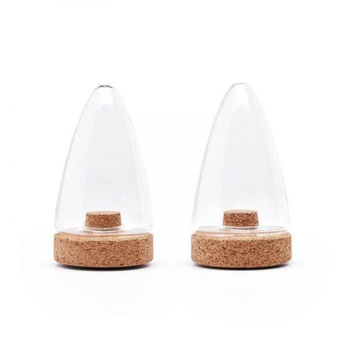 Glass salt and pepper shakers with cork stoppers, set of two, on a neutral background.