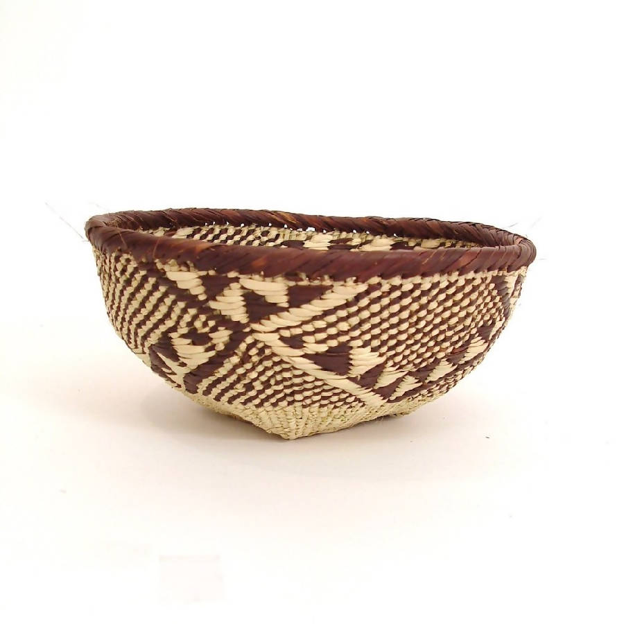 Handwoven Tonga basket bowls, natural fiber with an intricate weave for storage.
