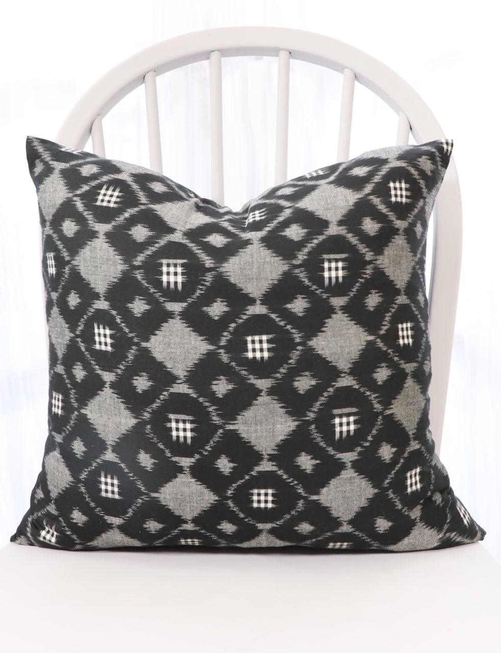 Handwoven black and grey ikat cotton throw pillow cover, pattern detail.