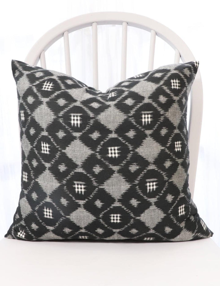 Handwoven black and grey ikat cotton throw pillow cover, pattern detail.