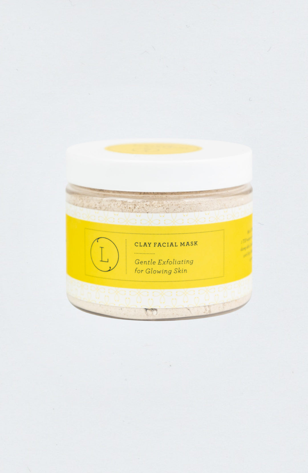 Clay facial mask in a bowl with an earthy texture.