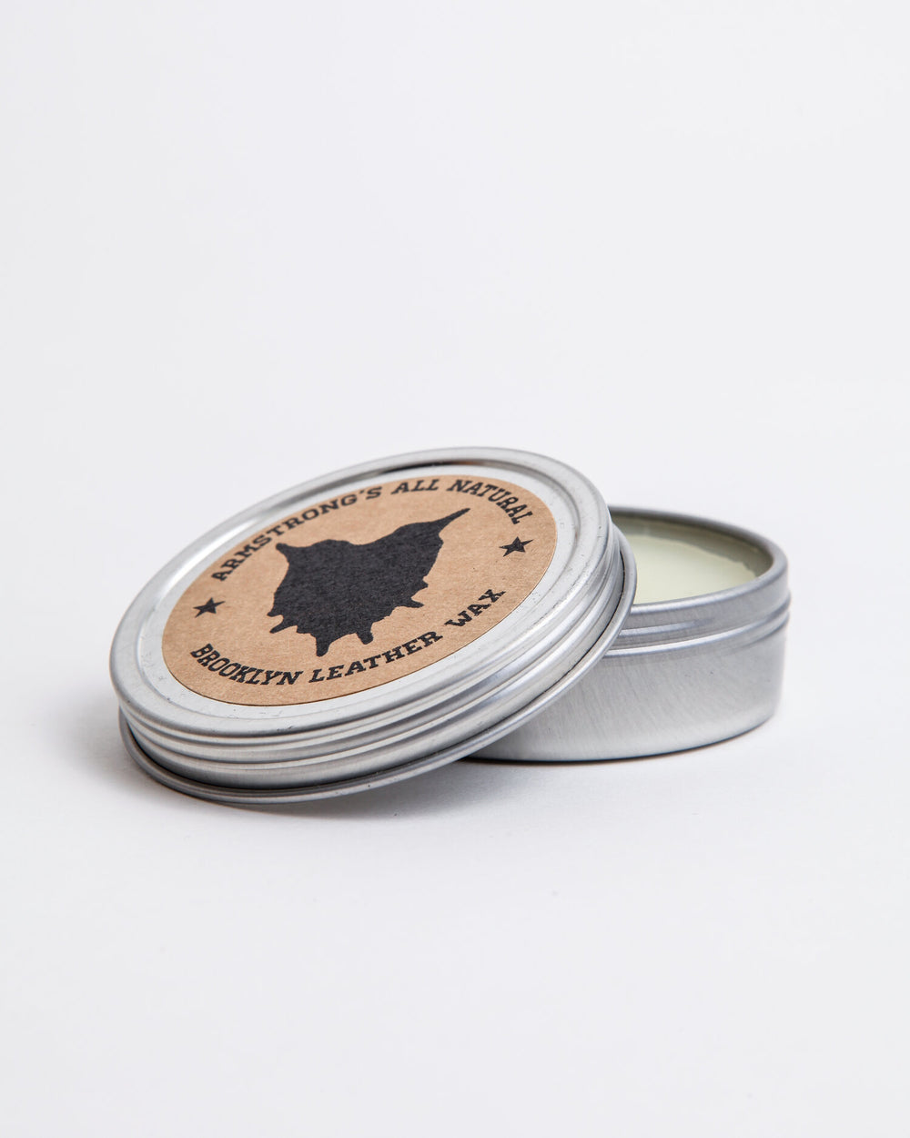Brooklyn Leather Wax in a tin with a wooden applicator.
