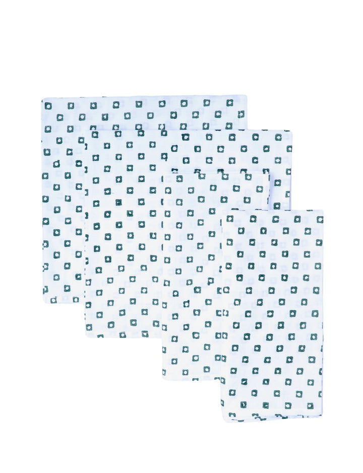 Set of four cotton napkins with a green square block print.