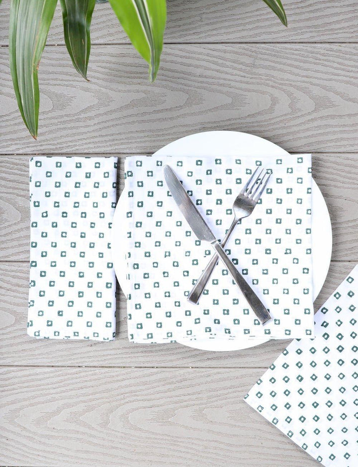 Set of four cotton napkins with a green square block print.