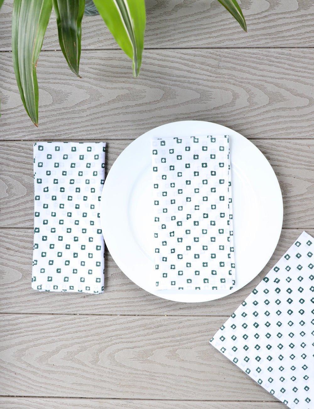 Set of four cotton napkins with a green square block print, for the table.