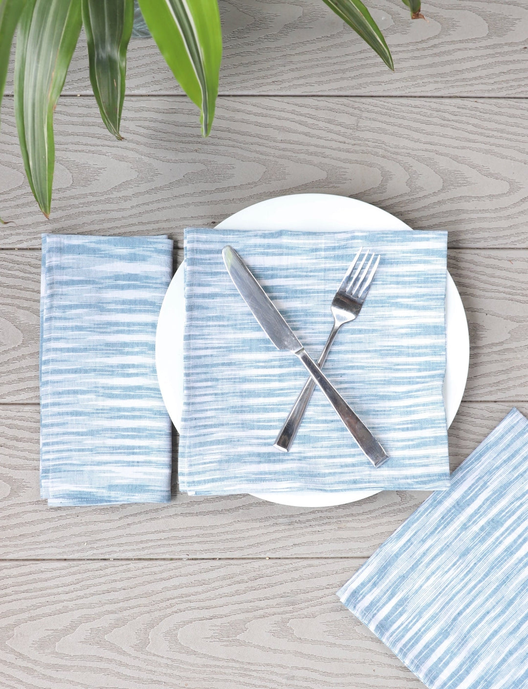 Set of four light blue handwoven cotton napkins, woven detail.