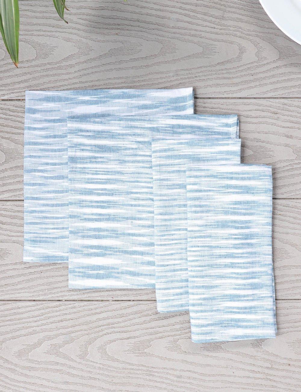 Set of four light blue handwoven cotton napkins.