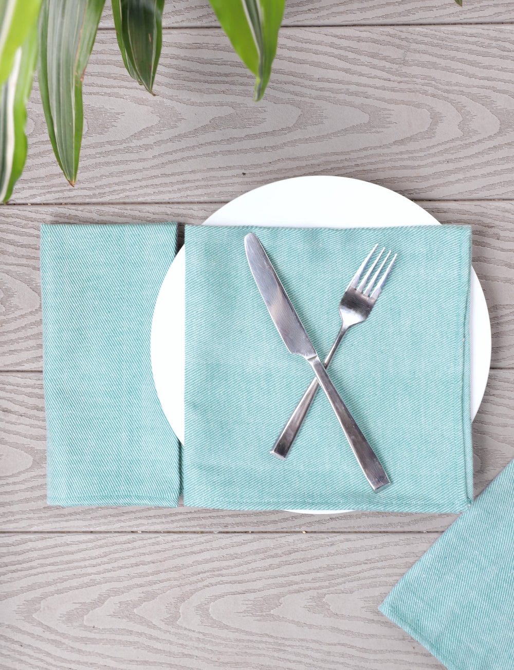 Set of four mint green handwoven cotton dinner napkins.