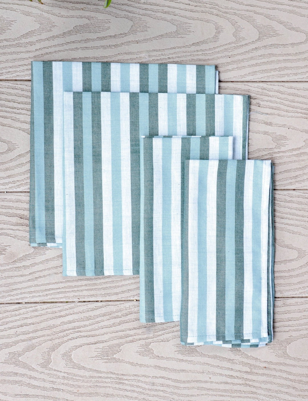 Set of four blue and white striped cotton napkins.