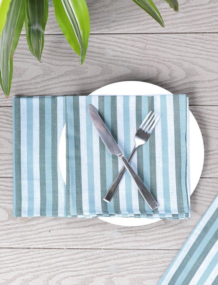 Set of four blue and white striped cotton napkins.