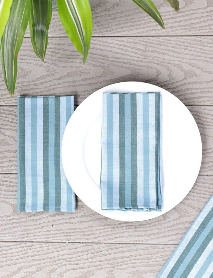 Set of four blue and white striped cotton napkins for the table.