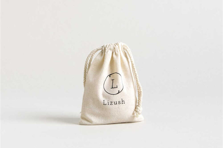 Natural lip balm set in a Lizush cotton bag.