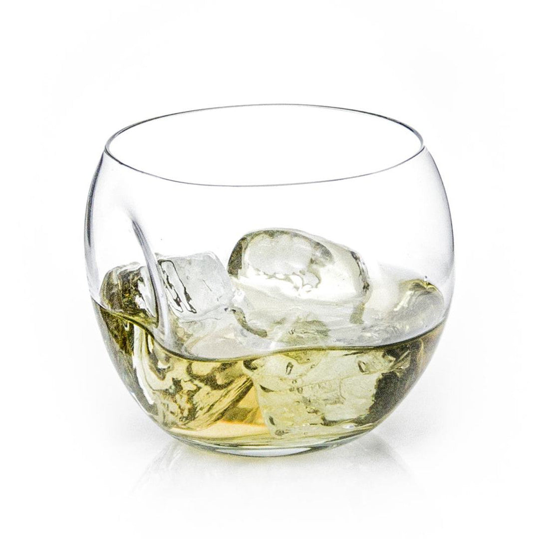 Dented round whiskey tumbler in recycled glass with a textured surface.