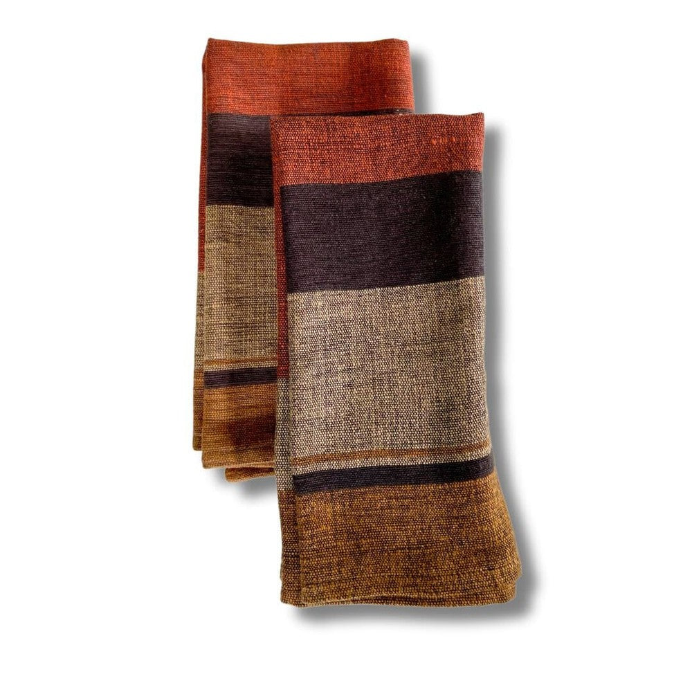 Pair of copper color block cotton dinner napkins, folded