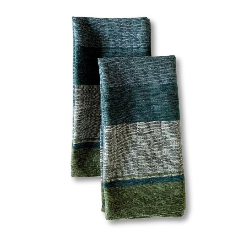 Pair of steel blue handwoven Ethiopian cotton dinner napkins with broad color bands, folded, on a white background