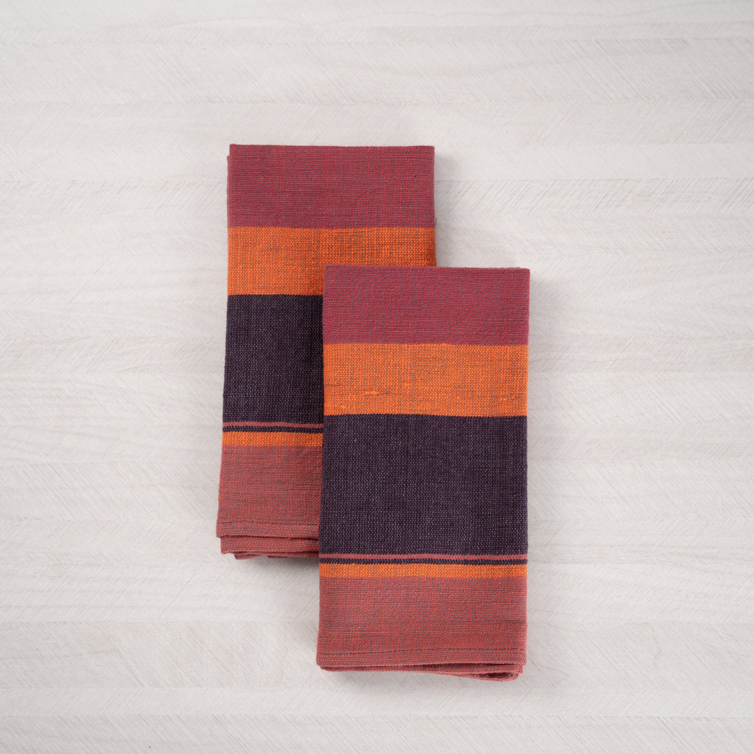 Pair of plum color block cotton dinner napkins, folded