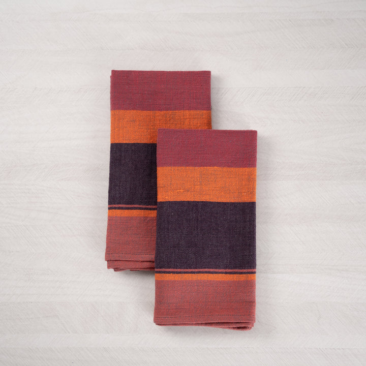 Pair of plum color block cotton dinner napkins, folded