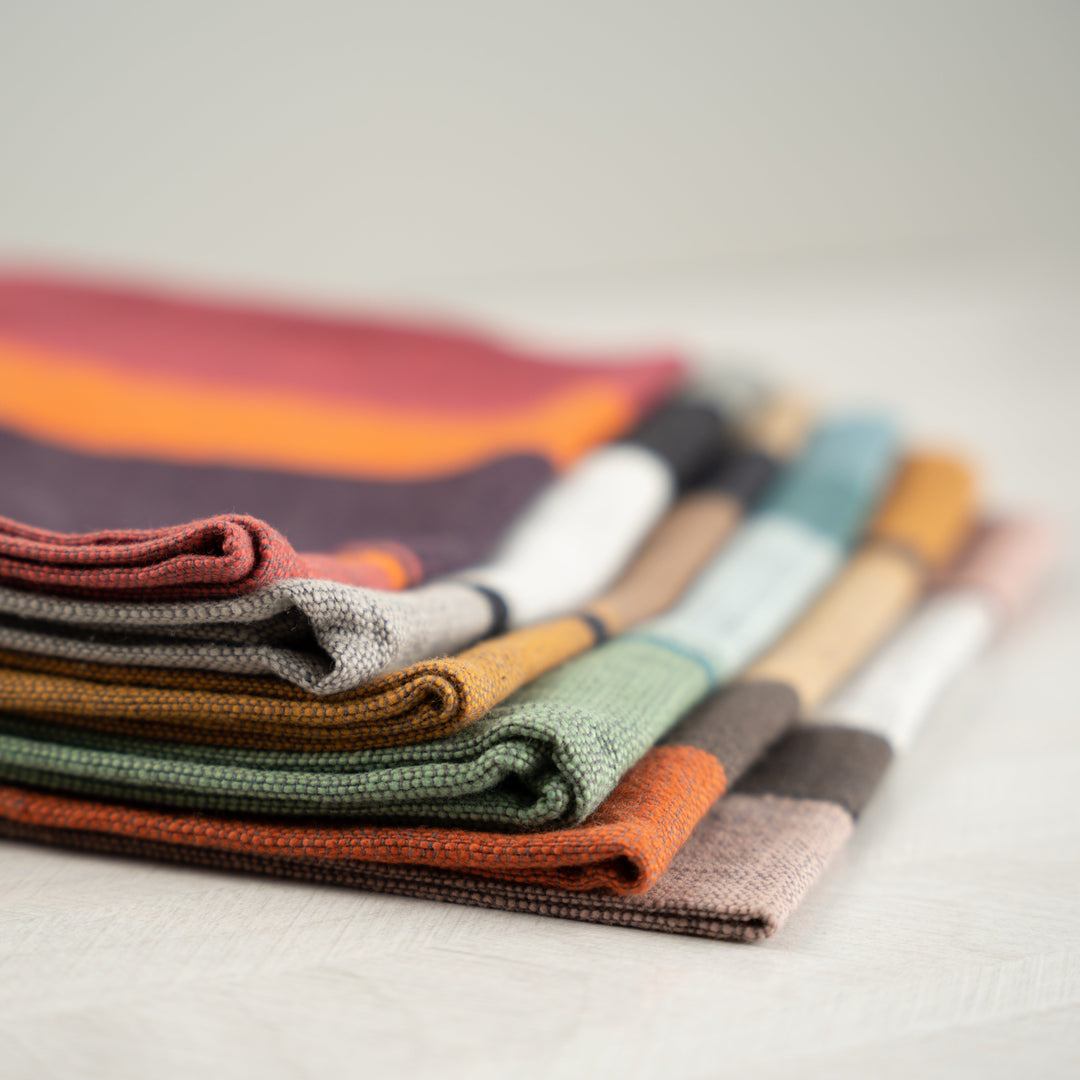 Close-up of folded color block napkins stacked on their side