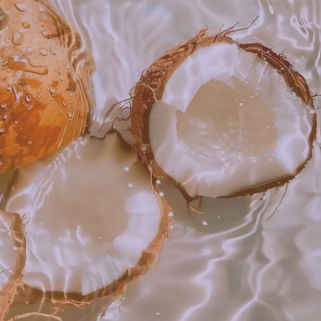 Organic coconut milk body lotion in a bottle with a tropical design.