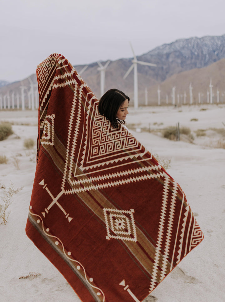 Rust-toned Achuar Autumn blanket with cream Andean geometric, made in Ecuador.