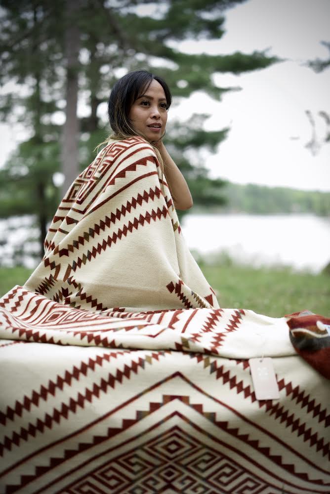 Beyond Borders Collective Achuar Autumn blanket, warm rust ground with olive band.