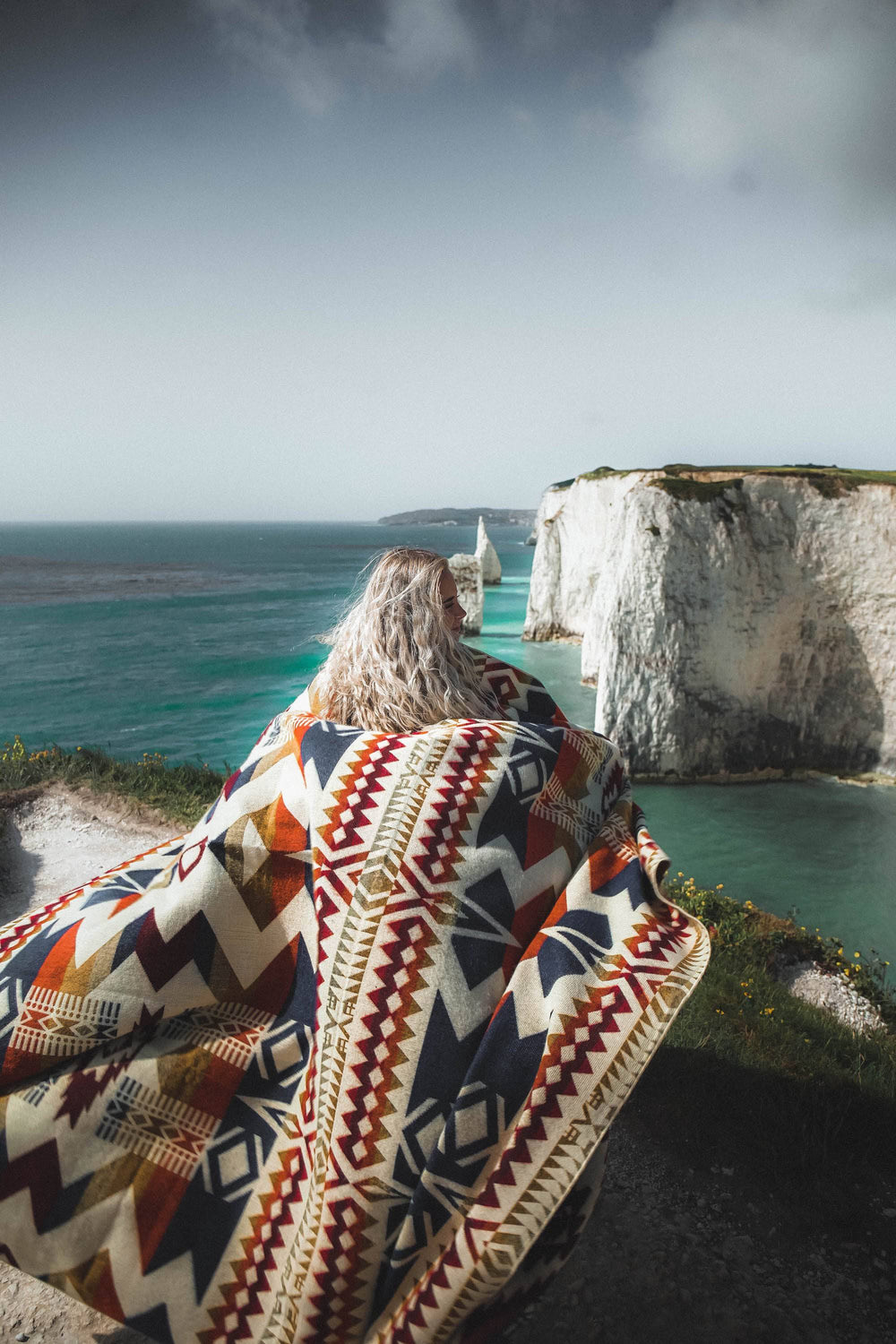 Vibrant Autumn Awa blanket showing the warm geometric weave with a bound edge.