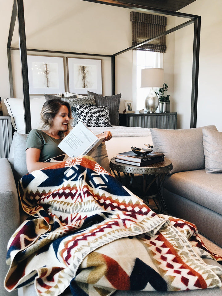 Handwoven Awa Vibrant Autumn blanket in rust, burgundy, navy, and olive on cream.