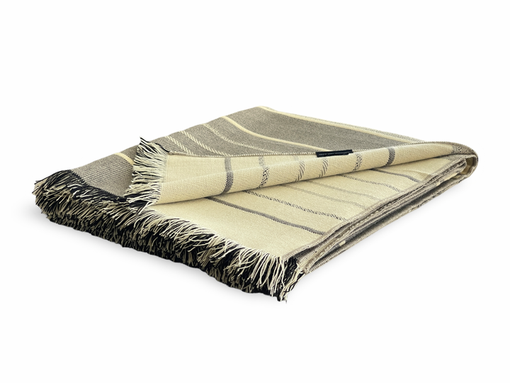 Handwoven Andean fringed throw in neutral cedar tones, made in Ecuador.