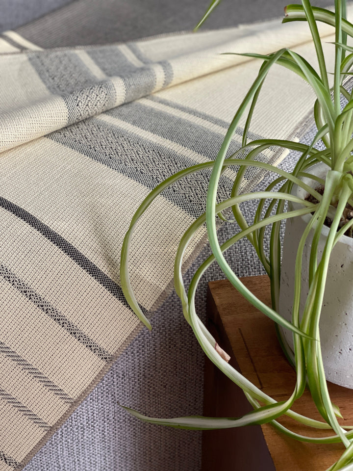 Cream and grey-brown Equinoccio throw in 100% recycled acrylic, 70 by 55 inches.