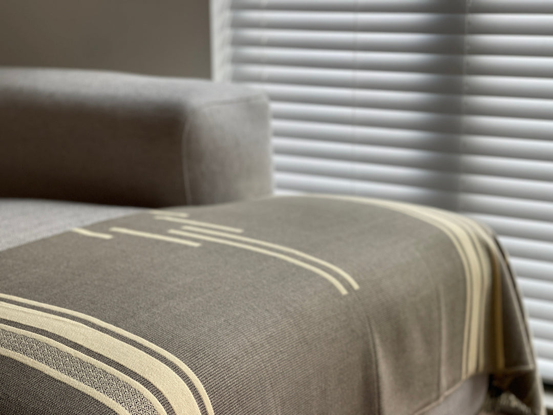 Beyond Borders Collective Equinoccio fringed throw in cedar-brown banded stripes.
