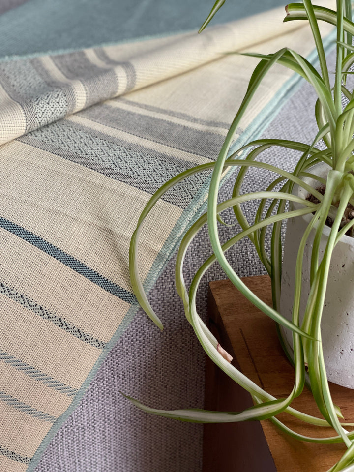 Handwoven Andean fringed throw in soft mint and sage tones, made in Ecuador.