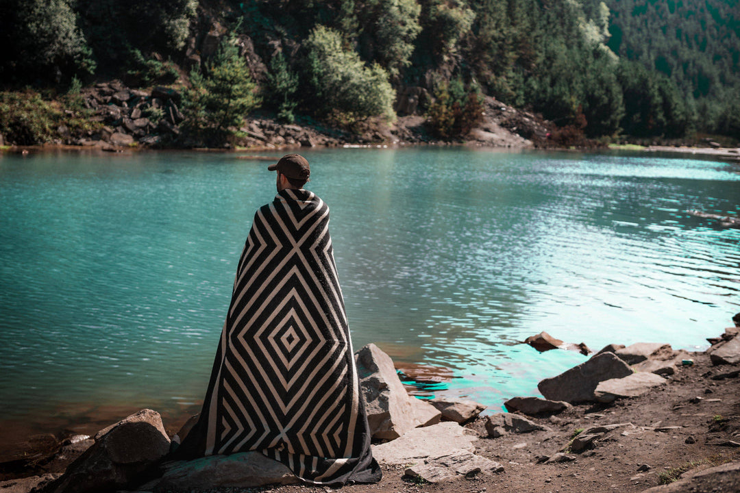 Paramo blanket in black and cream draped over an armchair.