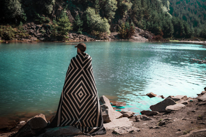 Paramo blanket in black and cream draped over an armchair.