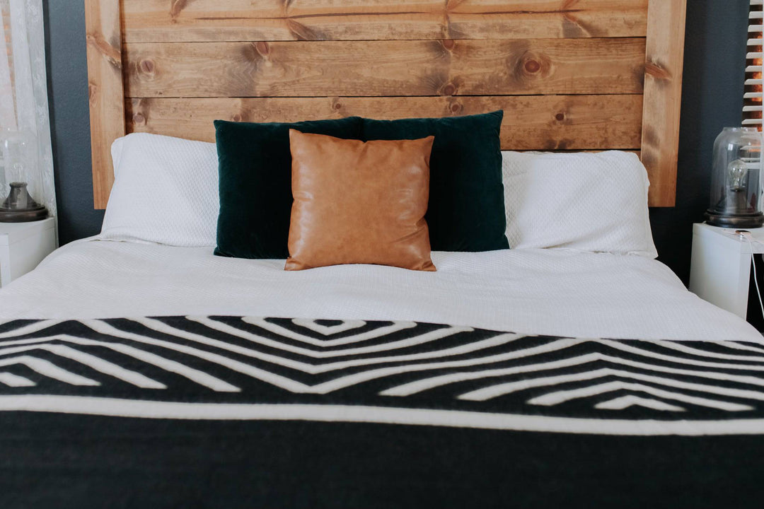 Beyond Borders Collective Paramo blanket in monochrome black and cream geometric.