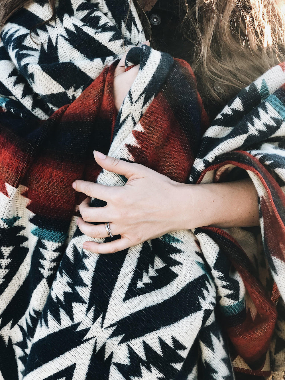 Campfire Andean blanket with navy diamonds and bold red and orange bands.