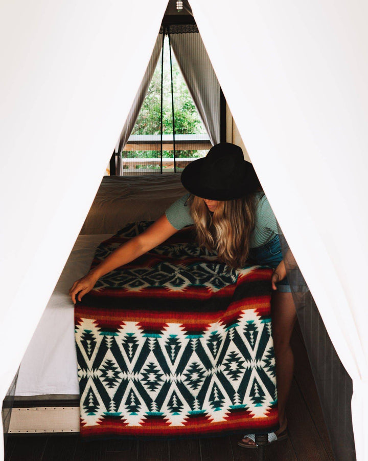 Campfire Andean blanket with vibrant red, orange, and navy geometric bands.