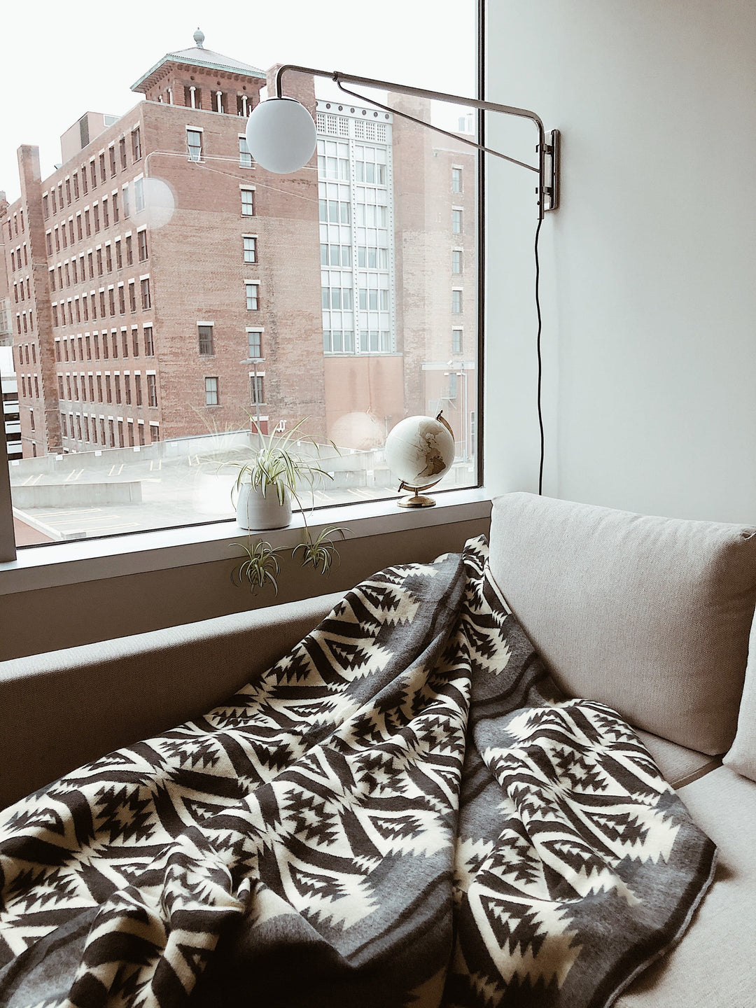 Greyscale Andean blanket folded to show the monochrome geometric pattern.