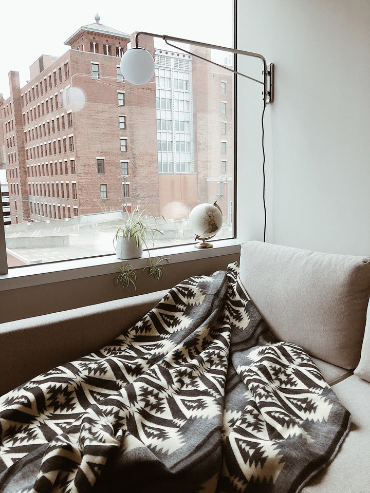 Greyscale Andean blanket folded to show the monochrome geometric pattern.