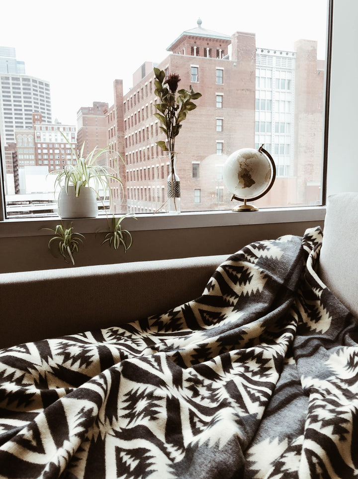 Greyscale Andean blanket with a black and white geometric pattern.