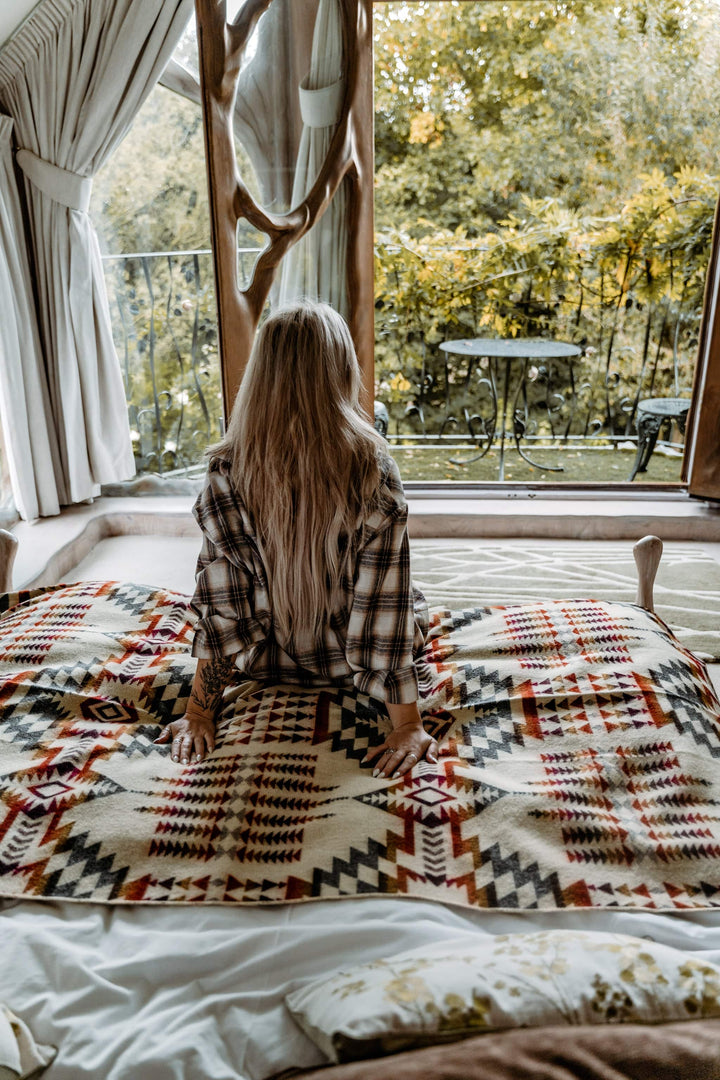 Campfire Ash throw blanket showing the diamond-and-stepped pattern in muted tones.