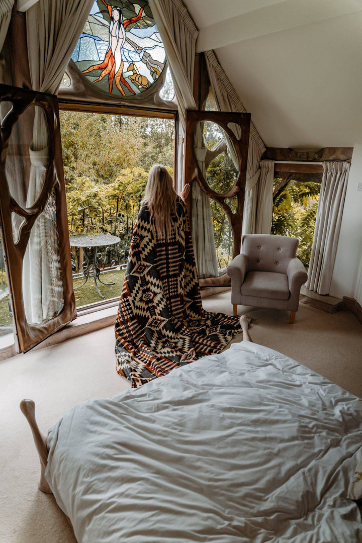 Campfire Ash Andean throw blanket with an earthy cream and rust geometric weave.