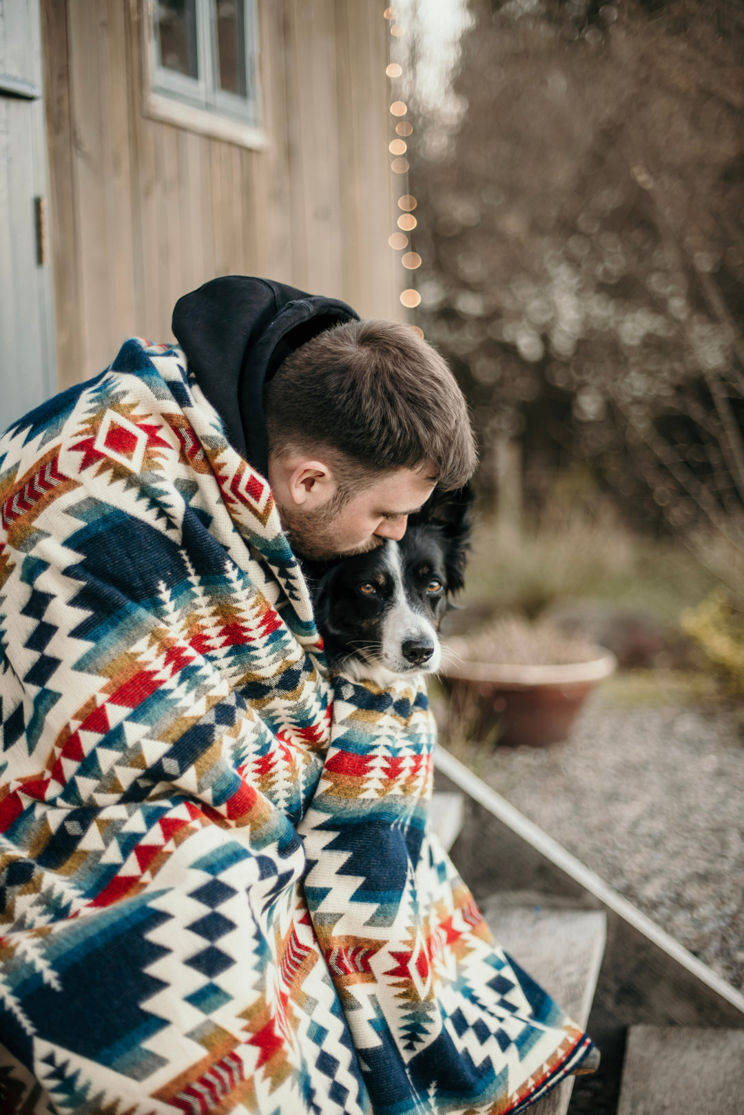 Northern Lights Andean throw blanket with a navy and red geometric weave.