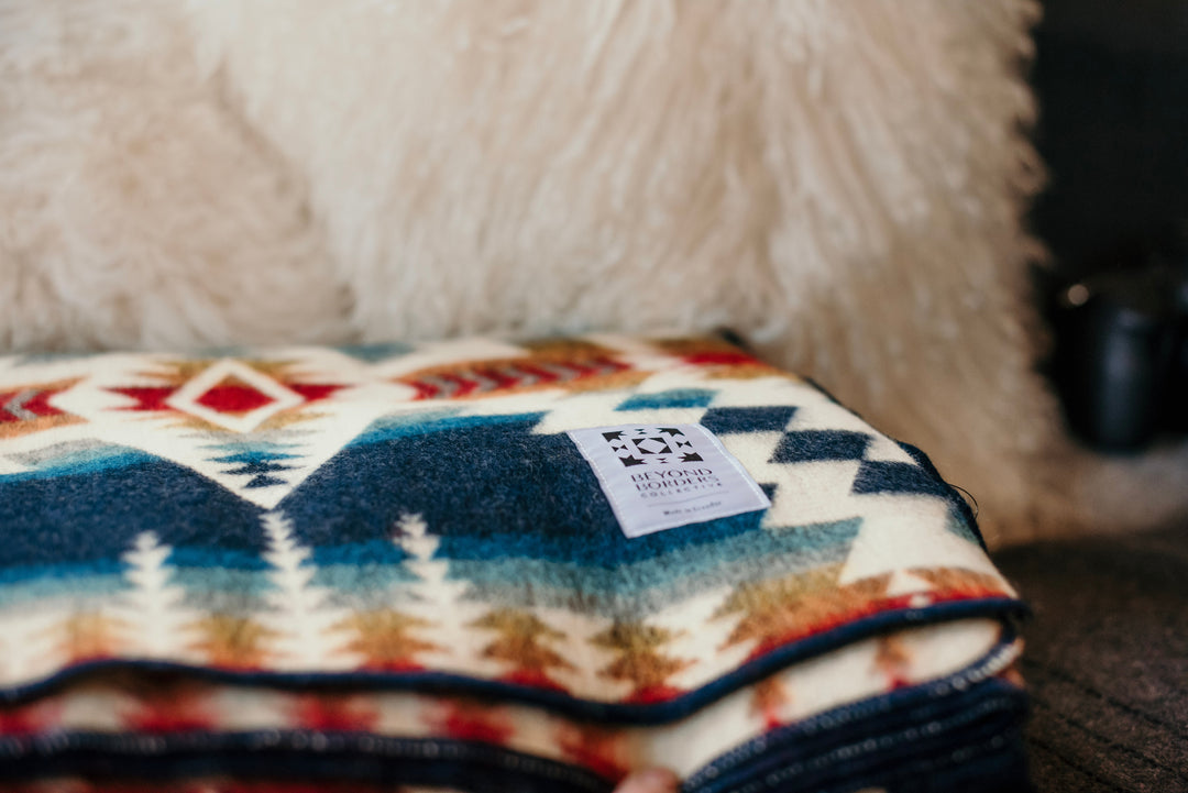 Northern Lights Andean throw blanket folded to show the geometric pattern.