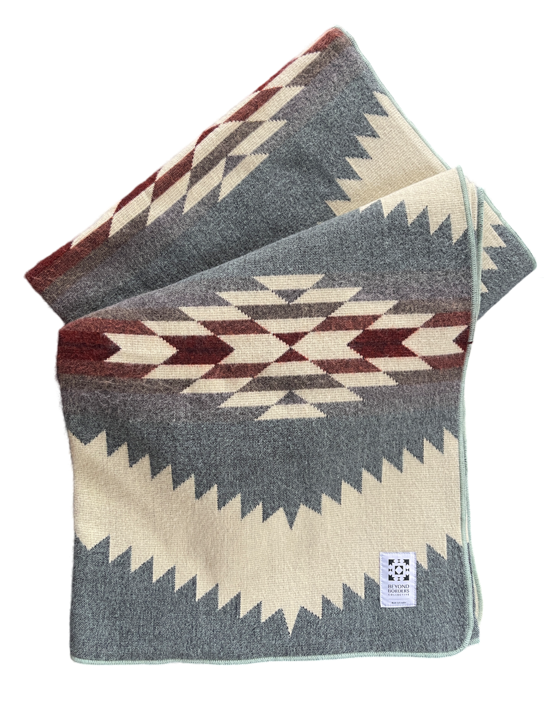 Tsachila Seaside Canyon Andean blanket in grey with cream, burgundy, and brown stepped diamond pattern and sage-mint bound edge.